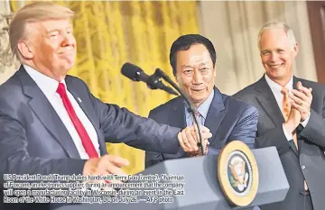  ??  ?? US President Donald Trump shakes hands with Terry Gou (centre), Chairman of Foxconn, an electronic­s supplier, during an announceme­nt that the company will open a manufactur­ing facility in Wisconsin, during an event in the East Room of the White House...