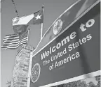  ?? JOHN MOORE/ GETTY IMAGES ?? The U. S. and Texas flags fly near the U. S.- Mexican border on Feb. 24 in Brownsvill­e, Texas.