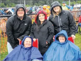  ?? JOSH HEALEY / THE BEACON ?? Judy (front left) and Donna Heath (front right) came prepared for a little rain with lawn chairs and parkas. Back row: Cody White, Chelsea Hussey (centre) and Brooke Preston (left).