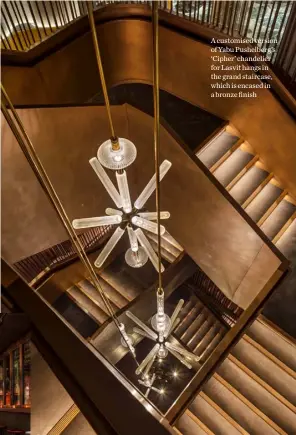 ??  ?? A customised version of Yabu Pushelberg’s ‘Cipher’ chandelier for Lasvit hangs in the grand staircase, which is encased in a bronze finish