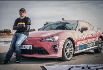  ??  ?? Jesse Adams leans on the Toyota 86 after setting the Guinness World Record for the longest vehicle drift at Gerotek test facility, in Pretoria.