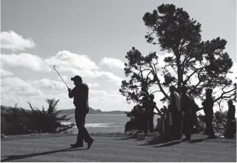  ?? AP PHOTO/ERIC RISBERG ?? Phil Mickelson hits from the No. 5 tee during the final round of the AT&amp;T Pebble Beach Pro-Am on Sunday in Pebble Beach, Calif. Mickelson led by three strokes when play was suspended due to darkness.