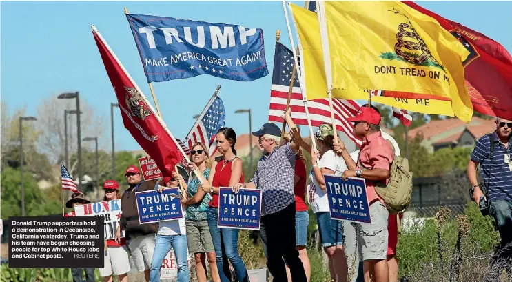  ??  ?? Donald Trump supporters hold a demonstrat­ion in Oceanside, California yesterday. Trump and his team have begun choosing people for top White House jobs and Cabinet posts.