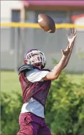  ??  ?? Senior wide reciever Tyler Erwin looks to connect with a pass.