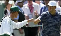  ?? ROBERT F. BUKATY — THE ASSOCIATED PRESS ?? Scottie Scheffler, right, pumps fists with his caddie Ted Scott after a birdie chip on the third hole during the final round of the Masters Sunday. Scheffler finished with a 71to win by 3strokes.