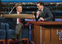  ?? MICHELE CROWE, THE ASSOCIATED PRESS ?? Jon Stewart appeared on Stephen Colbert’s “Late Show” Tuesday dressed as President Donald Trump with an exaggerate­dly long tie and animal skin cap.