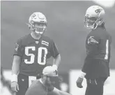  ?? AP ?? Patriot QBS Mac Jones and Cam Newton work through a drill during Patriots training camp at Gillette Stadium in Foxborough, Mass. on July 28.