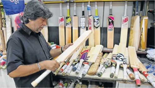  ?? Picture: AFP PHOTO / INDRANIL MUKHERJEE ?? CRAFTSMAN TO THE STARS: Bat-maker Aslam Chaudhry checks a cricket bat at his workshop in Mumbai