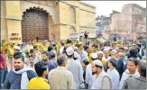  ?? PTI ?? People gather at the site during the survey of Gyanvapi Masjid complex in Varanasi on Saturday.