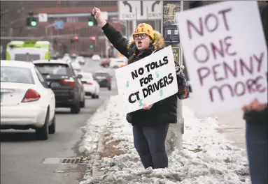  ?? Jessica Hill / Associated Press ?? Hilary Gunn, of Greenwich, protests the idea of tolls on Connecticu­t roads outside the State Capitol after Connecticu­t Gov. Ned Lamont delivered his budget address in Hartford, on Feb. 20.