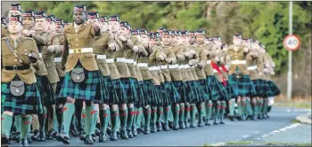  ??  ?? Above, the Highlander­s on parade ahead of their annual Christmas service at Catterick Garrison; and left, trophies were handed out after the sports tournament.