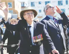  ?? JEAN LEVAC /POSTMEDIA NEWS FILES ?? Andy Carswell, left, is joined by his son John at a fly-past by a restored Canso after the cornerston­e dedication for the Andy Carswell Building for homeless veterans in Ottawa in September 2019.