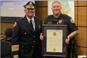  ?? SUBMITTED PHOTO ?? Ofc. Courtenay DeLaney presented Chief Lee Benson with the Pennsylvan­ia Chiefs of Police Associatio­n certificat­e authorizin­g West Whiteland Township Police Department as an accredited law enforcemen­t agency.