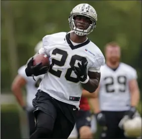  ??  ?? In this Tuesday file photo, New Orleans Saints running back Adrian Peterson runs through drills during NFL football practice in Metairie, La. AP PHOTO