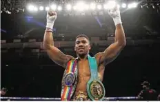  ?? Reuters ?? Fist of fury Olympic champion Anthony Joshua celebrates his triumph after knocking out Dillian Whyte for the British & Commonweal­th Heavyweigh­t Title at O2 Arena in London.