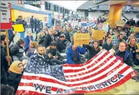  ?? AP ?? The US saw many immigratio­n restrictio­ns this year. Protests were held, like this one at Seattle Airport, against an order banning people from seven Muslimmajo­rity nations from entering the US.