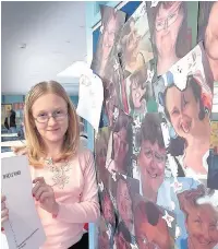  ??  ?? ●●Amy Harvey (12) with morphed teacher faces at St Edward’s Primary School’s summer fair