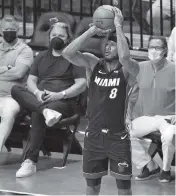  ?? DAVID SANTIAGO dsantiago@miamiheral­d.com ?? Heat forward Trevor Ariza hits a three-pointer against the Brooklyn Nets in Miami’s victory this past Sunday.