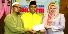  ??  ?? Rina (right) presents donations to Baitul Ehsan Al-Khairi Manager, Muhammd Zaman (left) at a Felcra Hari Raya celebratio­n in Kuala Lumpur. — Bernama photo