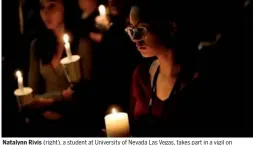  ?? GREGORY BULL / AP ?? Natalynn Rivis (right), a student at University of Nevada Las Vegas, takes part in a vigil on Monday in Las Vegas. A gunman on the 32nd floor of the Mandalay Bay casino hotel rained automatic weapons fire down on the crowd of more thanr 20,000 at an outdoor country music festival on Sunday.