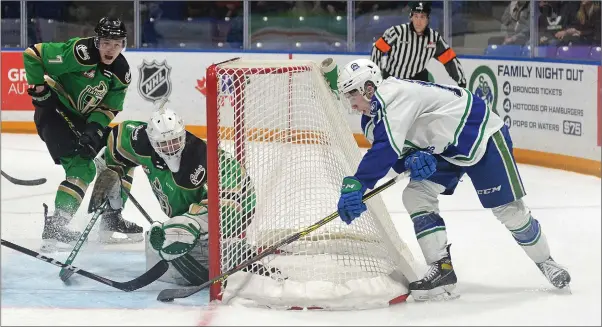  ?? STEVEN MAH/SOUTHWEST BOOSTER ?? Swift Current Broncos forward Josh Davies (right) came within inches of beating Prince Albert’s Tikhon Chayka with a wraparound during the final game of the 2021-22 season.