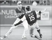  ?? Jayne Kamin-Oncea Getty Images ?? COREY SEAGER of the Dodgers takes a throw as Milwaukee’s Neil Walker breaks up a double play.