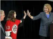  ?? ELAINE THOMPSON — THE ASSOCIATED PRESS FILE ?? Seattle Mayor Jenny Durkan, right, highfives Washington Wild hockey team wing Jaina Goscinski, 11, as Tod Leiweke, CEO of NHL Seattle, watches during a news conference in Seattle in October announcing plans to build a practice facility at Northgate Mall.