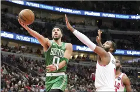  ?? CHARLES REX ARBOGAST/THE ASSOCIATED PRESS ?? Boston Celtics’ Jayson Tatum drives to the basket past Chicago Bulls’ Andre Drummond during the first half of the Bulls’ 121-107win on Monday night in Chicago.