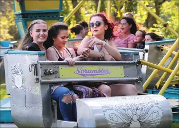  ?? Photos by Ernest A. Brown/The Call ?? From left, Abby Glaven-Hardy, 15, of Cumberland, Mickenzie Vargas, 14, also of Cumberland, and Gianna Fontaine, 15, of Blackstone, have fun on the Scrambler as Cumberland­Fest opened Friday night.