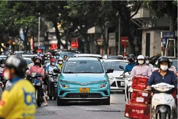  ?? ?? Struggling business: a Vinfast electric car on a street in Hanoi. Nearly all of the company’s retail sales in Vietnam are aided by hefty discounts offered through a joint marketing campaign with Vinhomes, according to reuters. — afp