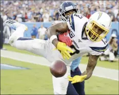  ??  ?? Los Angeles Chargers wide receiver Keenan Allen (13) can’t hold onto a pass in the end zone as he is defended by Tennessee Titans cornerback Logan Ryan in the fourth quarter of an NFL football game on Sunday, in Nashville, Tenn. AP PHOTO/JAMES KENNEY