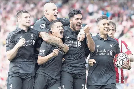  ?? AP ?? Liverpool’s Philippe Coutinho (lower centre, left) celebrates with teammates after scoring during the English Premier League football match between Stoke and Liverpool at the Britannia Stadium, Stoke, England, yesterday.