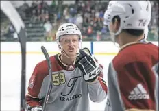  ??  ?? Jake Guentzel talks with Rangers defenseman Brady Skjei at a “Da Beauty League” game.