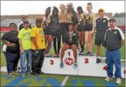  ?? CHRIS LILLSTRUNG — THE NEWS-HERALD ?? Beachwood’s Leah Roter, left, and Mia Knight proudly clutch the regional team title trophy May 27 after the Division II Austintown-Fitch Regional. It marks the first regional crown for the Bison girls in program history.