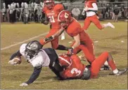  ?? Scott Herpst ?? Jevonnie Womble (3) tackles Coahulla Creek’s Titus Underwood as LFO defenders Malachi Wixom (47) and Jamillion Womble (11) move in to assist. However, Underwood would finish with 216 yards and four touchdowns as the Colts upended the Warriors, 34-21, last Tuesday night.