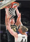  ?? Julie Jacobson ?? The Associated Press Michigan center Jon Teske dunks against Purdue center Isaac
Haas in the second half of the Wolverines’ 75-66 win Sunday.
