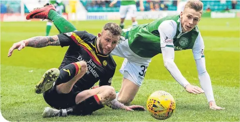  ??  ?? Partick Thistle’s Christie Elliott wins the ball from Hibernian’s Oli Shaw at Easter Road yesterday