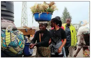  ?? AP ?? People wash their hands Thursday on the Congo side of the Poids Lourd checkpoint on the border with Rwanda when Rwanda briefly closed the border over Ebola concerns.