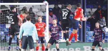  ?? Reuters ?? ↑
Luton Town’s Matthew Pearson scores against Norwich as a limited number of fans look on during their English Championsh­ip match on Wednesday.