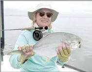  ??  ?? Carol Phillips was photograph­ed during a fishing trip to Florida with a pompano. Upon moving to Bella Vista, her first stop was the Fly Tyers Club.
