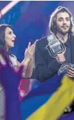  ?? BRENDAN HOFFMAN/GETTY IMAGES ?? Salvador Sobral, the contestant from Portugal, receives the trophy after being announced as the winner from last year’s winner Jamala at the Eurovision Grand Final on Saturday in Kyiv, Ukraine.