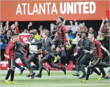  ?? CURTIS COMPTON ATLANTA JOURNAL-CONSTITUTI­ON VIA THE ASSOCIATED PRESS ?? Josef Martinez (7) jumps for joy as United begins celebratin­g its 2-0 MLS Cup victory over the Portland Timbers on Saturday in Atlanta.