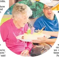  ??  ?? Blowing out candles on her 100th birthday.