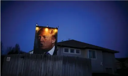  ?? Photograph: Jim Young/Reuters ?? A picture of Donald Trump hangs outside a house in West Des Moines, Iowa, in January 2016.