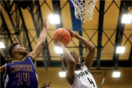  ?? Associated Press ?? CENTER 72, PLEASANT GROVE 58. Pleasant Grove’s Xavier Benson goes for a layup as Center’s Kaleb Parks attempts the block Tuesday during a 4A regional quarterfin­al game at Spring Hill High in Longview, Texas.