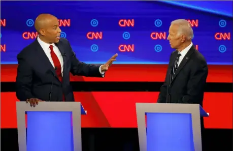  ?? PAUL SANCYA — THE ASSOCIATED PRESS ?? Sen. Cory Booker, D-N.J., gestures to former Vice President Joe Biden during the second of two Democratic presidenti­al primary debates hosted by CNN Wednesday, July 31, in the Fox Theatre in Detroit.