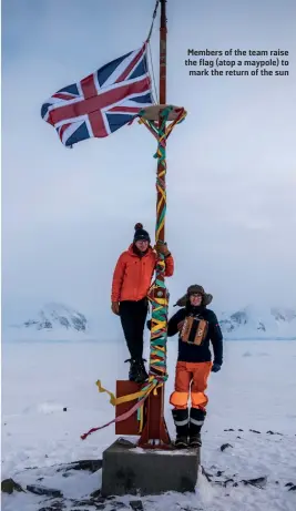  ??  ?? Members of the team raise the flag (atop a maypole) to mark the return of the sun