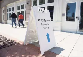  ?? Tyler Sizemore / Hearst Connecticu­t Media ?? A sign leads to check-in for the student dorms at the UConn Stamford branch in Stamford on Aug. 17. Health experts say active screening for COVID-19 is critical in preventing college outbreaks.