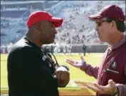  ?? STEVE CANNON — THE ASSOCIATED PRESS ?? In this Nov. 18, 2017, file photo, Florida State’s head coach Jimbo Fisher, right, meets Delaware State’s head coach Kenny Carter at midfield before the start of an NCAA college football game in Tallahasse­e Fla.