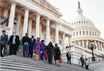  ?? New York Times file photo ?? Congressio­nal Black Caucus members walk down the steps of the U.S. Capitol. Some members, especially progressiv­e ones, have called for the group to take on a more combative activist role.